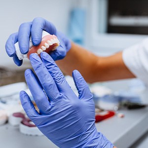 A lab technician working on dentures