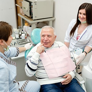 Dentist discussing dentures with a patient